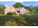 Brick house exterior with a deck and large backyard at 108 Cottonwood Dr, Mount Holly, NC 28120
