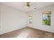 Simple bedroom with carpet flooring and two windows with blinds at 108 Cottonwood Dr, Mount Holly, NC 28120