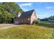 Brick house exterior with a large backyard and detached garage at 108 Cottonwood Dr, Mount Holly, NC 28120
