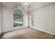 Bright bedroom with wall-to-wall carpet and large arched window at 108 Cottonwood Dr, Mount Holly, NC 28120