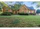 Two story brick home with landscaped lawn at 108 Cottonwood Dr, Mount Holly, NC 28120