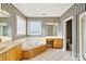 Main bathroom with corner jacuzzi tub and double vanity at 108 Cottonwood Dr, Mount Holly, NC 28120