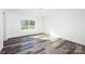 Bedroom with wood-look floors and large window at 455 Playground Ln # 6, Salisbury, NC 28146