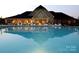 Evening view of community pool with clubhouse in the background at 12821 Mayes Rd, Huntersville, NC 28078