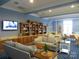 Community library with bookshelves, comfortable seating, and a TV at 12821 Mayes Rd, Huntersville, NC 28078