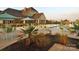 Community pool with lounge chairs, tables, and umbrellas at 12821 Mayes Rd, Huntersville, NC 28078