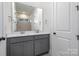 Modern bathroom with dual vanity, gray cabinets, and a large mirror at 1336 Sage Pine Cir # 21, Clover, SC 29710