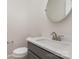 Powder room with gray vanity, quartz countertop, and a round mirror at 1336 Sage Pine Cir # 21, Clover, SC 29710