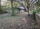 Small cottage with a front porch and overgrown yard at 213 Belt Dr, Lowell, NC 28056