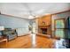 Spacious living room with hardwood floors, a brick fireplace, and lots of natural light at 8321 Knights Ct, Harrisburg, NC 28075