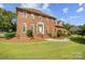 Brick house exterior, two-story, with landscaping and walkway at 8321 Knights Ct, Harrisburg, NC 28075