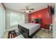 Bedroom with red accent wall, ceiling fan, and queen-size bed at 119 Bluff Ct, Statesville, NC 28625