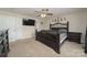 Bedroom with ceiling fan, large bed, and dark wood furniture at 119 Bluff Ct, Statesville, NC 28625