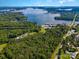 Aerial view showcasing a lakefront property near a marina and road at 4516 Slanting Bridge Rd, Sherrills Ford, NC 28673