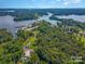 Aerial view showing lakefront property with boat slips and surrounding landscape at 4516 Slanting Bridge Rd, Sherrills Ford, NC 28673