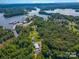 Aerial view of lakefront property with lush trees and a marina at 4516 Slanting Bridge Rd, Sherrills Ford, NC 28673