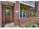 Inviting front entrance with a wooden door and brick detailing at 112 S Summit Ave, Charlotte, NC 28208