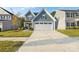 Two-story home with gray siding, two-car garage, and landscaped lawn at 1332 Lena St, Monroe, NC 28112