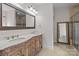 Double vanity bathroom with marble countertop and large mirror at 4532 Lanstone Sw Ct, Concord, NC 28027