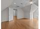 Spacious bedroom with hardwood floors and access to a hallway at 4532 Lanstone Sw Ct, Concord, NC 28027