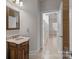 Small bathroom with vanity and view into another room at 4532 Lanstone Sw Ct, Concord, NC 28027