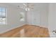 Bright bedroom with hardwood floors, ceiling fan, and double doors at 4532 Lanstone Sw Ct, Concord, NC 28027
