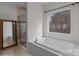 Bathroom with soaking tub, shower, and stained glass window at 4532 Lanstone Sw Ct, Concord, NC 28027
