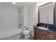 Bathroom with shower/tub combo and dark vanity at 4532 Lanstone Sw Ct, Concord, NC 28027