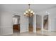 Bright dining room featuring a chandelier and views into the kitchen at 4532 Lanstone Sw Ct, Concord, NC 28027