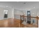 Upstairs hallway overlooking the living room and stone fireplace at 4532 Lanstone Sw Ct, Concord, NC 28027