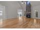 Living room with hardwood floors, stone fireplace and high ceilings at 4532 Lanstone Sw Ct, Concord, NC 28027