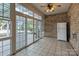 Sunroom with tile floor, brick wall, and sliding glass doors at 4532 Lanstone Sw Ct, Concord, NC 28027