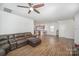 Open living area with hardwood floors and a large brown sectional sofa at 12009 Downy Birch Rd, Charlotte, NC 28227