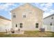 Tan house back with patio and fenced yard at 12009 Downy Birch Rd, Charlotte, NC 28227