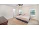 Main bedroom with carpeted floor, ceiling fan, and access to private bathroom at 12009 Downy Birch Rd, Charlotte, NC 28227