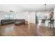 Spacious living room with hardwood floors, open to kitchen and breakfast bar at 12009 Downy Birch Rd, Charlotte, NC 28227