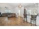 Open living room showcasing a spacious layout, hardwood floors, and a kitchen with breakfast bar at 12009 Downy Birch Rd, Charlotte, NC 28227