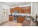 Modern kitchen with wood cabinets, granite countertops, and stainless steel appliances at 12009 Downy Birch Rd, Charlotte, NC 28227