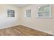 Well-lit bedroom with wood-look floors and multiple windows at 3500 Eller Dr, Newton, NC 28658