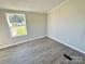 Spacious bedroom with large windows and wood-look floors at 155 Hickory Nut Dr, Statesville, NC 28677