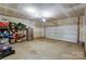 Spacious garage with overhead door and ample storage shelving at 5948 River Meadow Ct, Charlotte, NC 28213