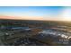 Aerial view of a residential area with commercial buildings and a large vacant lot at 5015 Mockernut Ln, Indian Land, SC 29707