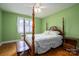 Bedroom with hardwood floors and a four-poster bed at 424 S College Ave, Newton, NC 28658
