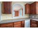 Kitchen features wood cabinets and an arched pass-through at 424 S College Ave, Newton, NC 28658