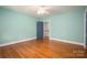 Light green walls, hardwood floors, and a ceiling fan at 424 S College Ave, Newton, NC 28658
