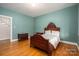 Bedroom with hardwood floors and antique furniture at 424 S College Ave, Newton, NC 28658