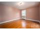 Simple bedroom with hardwood floors and neutral walls at 424 S College Ave, Newton, NC 28658