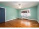 Light green walls, hardwood floors, and a ceiling fan at 424 S College Ave, Newton, NC 28658
