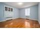 Light and airy bedroom with hardwood floors and window shutters at 424 S College Ave, Newton, NC 28658