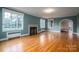 Spacious living room with hardwood floors, fireplace, and large windows at 424 S College Ave, Newton, NC 28658